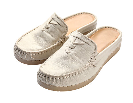 Pair of white leather moccasin style slip-on shoes on white background.