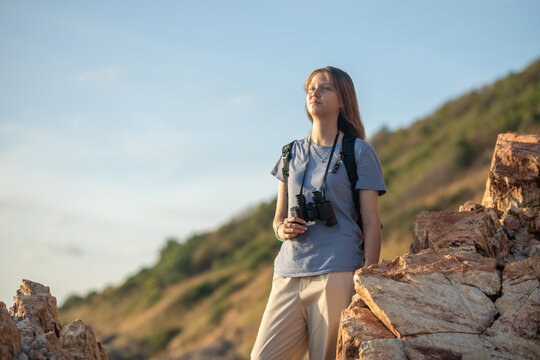 Hikers trekking through on nature trail using binoculars while the other enjoying outdoor adventure and exploration in a scenic countryside landscape representing active lifestyle and eco tourism.