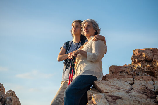 Hikers trekking through on nature trail using binoculars while the other enjoying outdoor adventure and exploration in a scenic countryside landscape representing active lifestyle and eco tourism.