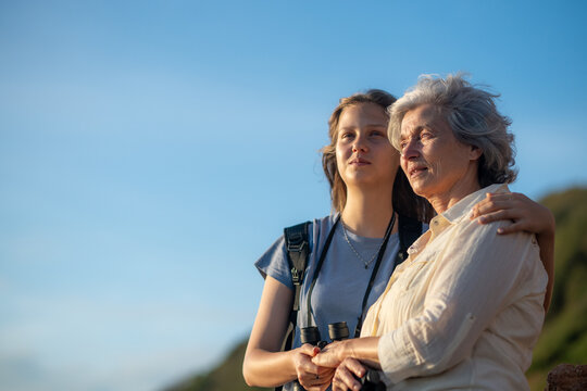Hikers trekking through on nature trail using binoculars while the other enjoying outdoor adventure and exploration in a scenic countryside landscape representing active lifestyle and eco tourism.