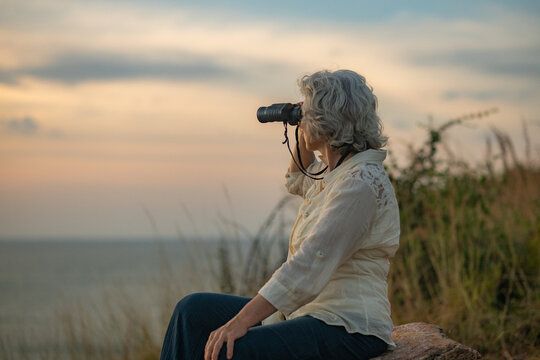 Hikers trekking through on nature trail using binoculars while the other enjoying outdoor adventure and exploration in a scenic countryside landscape representing active lifestyle and eco tourism.