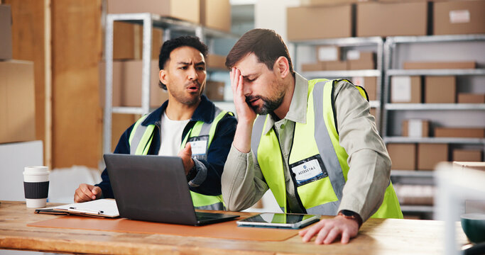 Laptop, distribution and men in warehouse, angry for delivery mistake and talking. Annoyed, pc and people in workplace, lost package or upset for transport error, website for shipping fail or delay