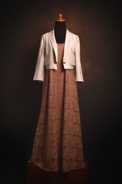 Brown classic lace dress with khaki crop blazer on a mannequin display