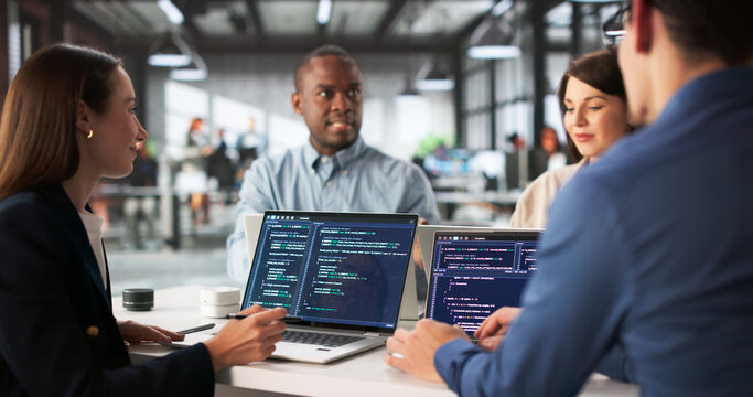 Diverse Group Of Engineers Collaborating On Software Development