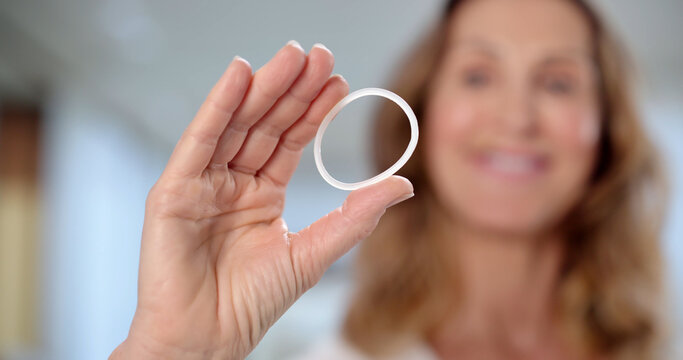 Smiling Woman, European Female Doctor Holding Vaginal Contraceptive