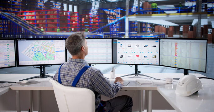 Older Caucasian Man Optimizing Warehouse Logistics