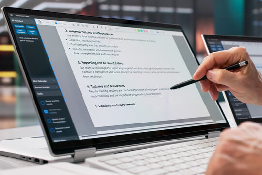 Man Reviewing Patient Privacy Document On Laptop