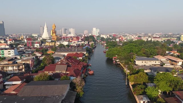 Golden buddha statue at wat paknam phasi charoen sunset sky with rivaer aerial view sightseeing travel in Bangkok Thailand 