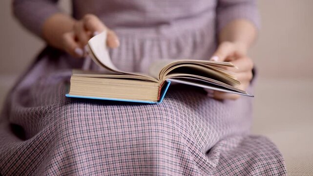 Student Turning Pages of Open Book. Education and Self-Development. Knowledge Acquisition