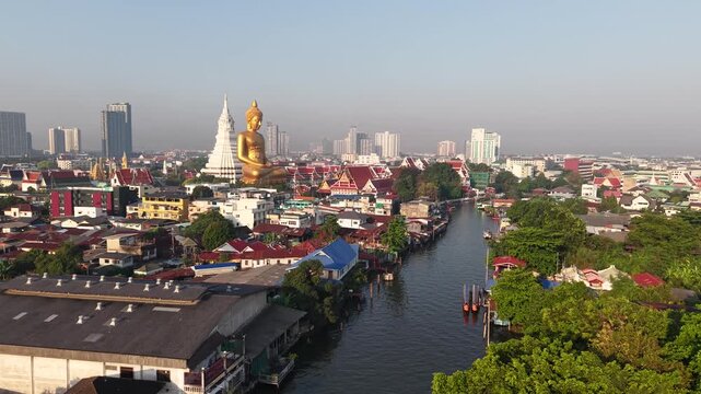 Golden buddha statue at wat paknam phasi charoen sunset sky with rivaer aerial view sightseeing travel in Bangkok Thailand 