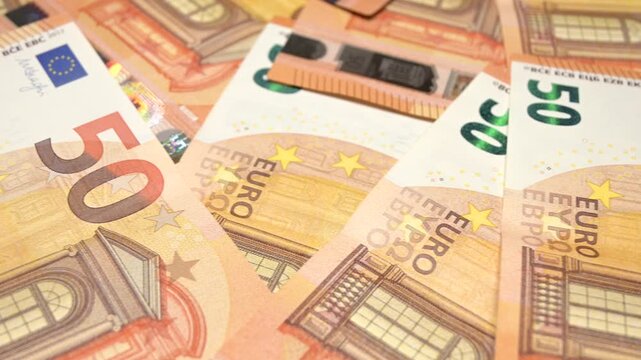 sliding shot of fifty euro banknotes closeup
