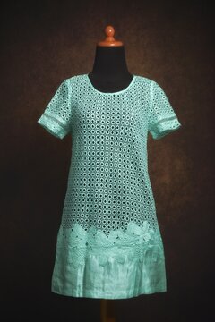 Soft Mint Green Lace brocade and Crochet dress on a mannequin display