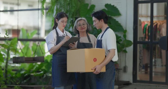 Mother, daughter, and son pose outside their family run ceramic shop and warehouse, presenting a friendly, professional team ready for retail and wholesale customers.
