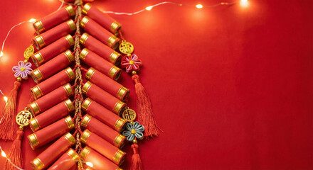 Red firecrackers decorated with flowers and lights on red background for chinese new year celebration © Sanoor