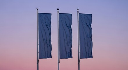 Three blue flags waving in the wind against a gradient sky at dusk.