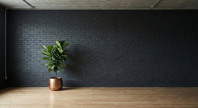 Lush green plant in brown pot on wooden floor against dark gray brick wall in minimalist room with natural light