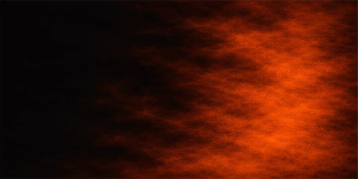 Dramatic fire flames dance against an abstract dark sky filled with orange sunset clouds and a red storm light for a beautiful nature landscape background