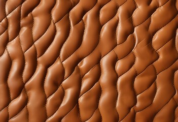 Fototapeta premium Soft upholstered leather or synthetic material featuring elegant wave stitched texture.