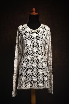 White lace crocheted top in close-up on display mannequin