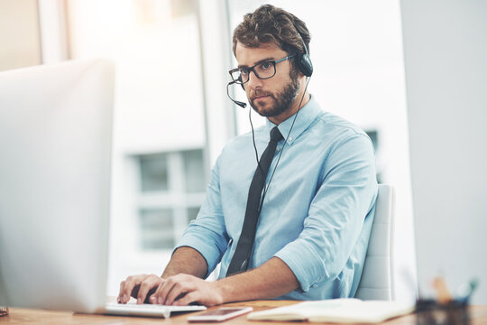 Computer, headset and man in call center for telemarketing, customer support and typing sales pitch. Lead generation, research and employee with tech for networking, log call outcome and client info