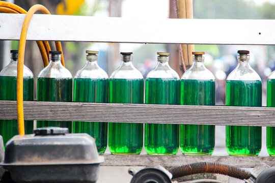 Pertalite type fuel oil (BBM) which is sold retail in glass bottles is sold by street vendors on the roadside