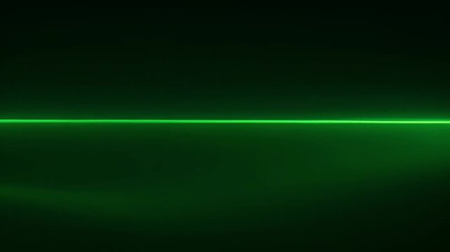 Horizontal green laser beam cutting through dark background, captured in high‑contrast view emphasizing precision and energy
