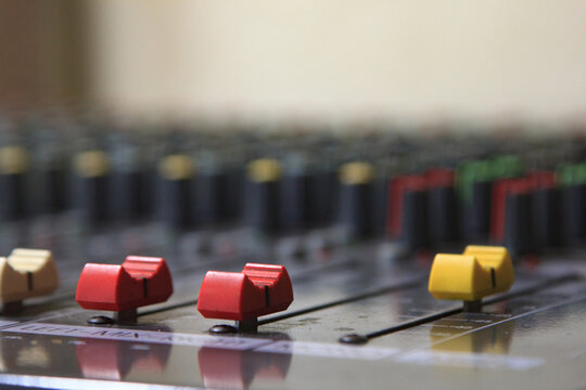 Volume sliders for professional digital audio mixers.