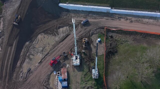 Aerial view of drilling rig creating foundation piles on construction site