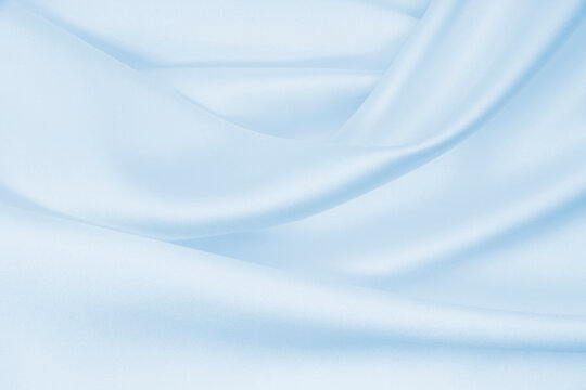 Smooth elegant blue silk or satin luxury cloth texture as abstract background. Luxurious background design