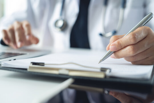 Doctor writing notes on clipboard for hospital schedule, history record or healthcare checklist. Doctor writing prescription, medication document for patient in hospital office