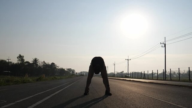 Athlete Stretching Forward on Road at Sunrise Morning Fitness Routine Concept