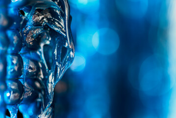 Blue technical grease forming hardened overhangs and stalactite-like drips. Thick viscous texture...