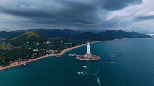 Aerial view sunset White statue GuanYin in buddhism center of Nanshan in Sanya, Hainan island, China.