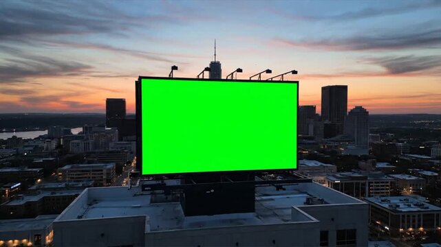 Cityscape Billboard with Green Screen at Sunset.