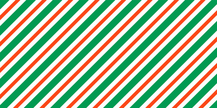 Christmas seamless pattern. Red and green diagonal stripes background. Candy cane repeating decoration wallpaper. Winter holiday lines backdrop. vector