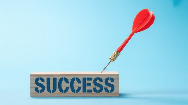 Red dart striking a wooden block with the word SUCCESS on a bright blue background representing achi