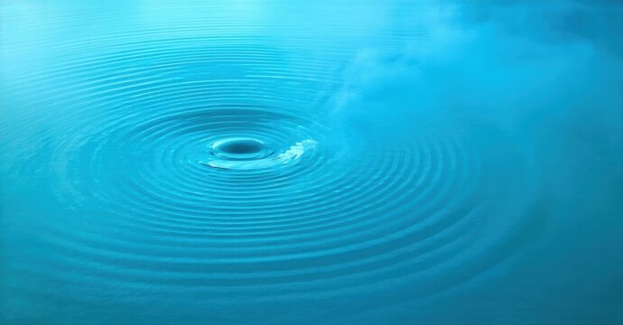 Water drop creates ripples. Blue tones dominate image. Calm surface disturbed by impact. Circular waves radiate outward. Peaceful scene.