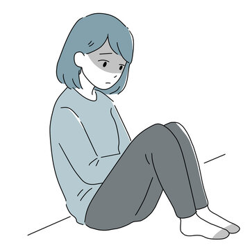 座って落ち込む女性 影あり