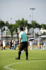 Obraz premium Professional soccer referee officiating a girls' youth football match with intensity and passion on the pitch.