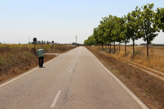 Senior man walking in July 2024 Rural road in Mansilla de las Mulas