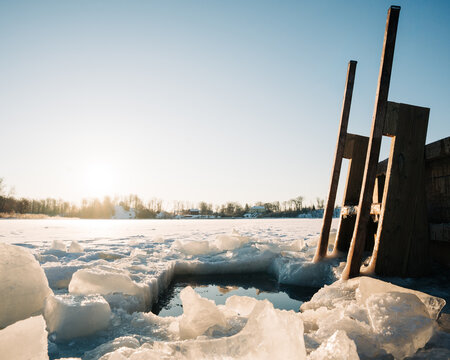 wooden steps going down to the frozen sea in the Swedish archipelago