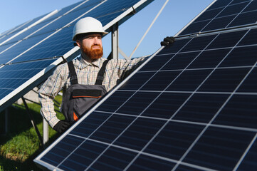 Engineer installing solar panels in solar power station for green energy