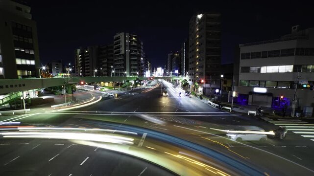A night timelapse of traffic jam at the downtown crossing in Tokyo wide shot