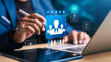 Business managing digital employee profiles on tablet and laptop with virtual HR interface. Concept of recruitment, talent management, team selection. © phimprapha