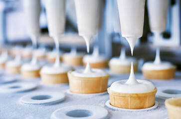 Ice cream production using automated conveyor systems. Shallow depth of field