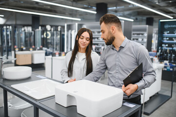 Naklejka premium Seller assisting female buyer choosing bathroom sink