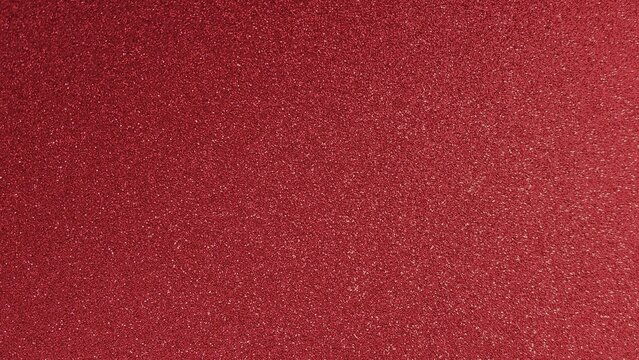 Sparkling red glitter shiny abstract texture background. Red shimmer surface with glowing sparkle particles. Luxury glitter glow backdrop.