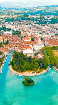 Vertical video. Annecy, France. Historical city center with the Thiou river. Annecy is a city in the Alps in southeastern France. Drone footage, Departure of the camera. Rich colors