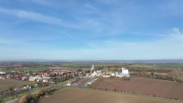 Factory sugar beet food processing aerial drone view slow motion video at Central Moravia Czech Republic. Building and house construction site, residential and commercial area farming and agricultural