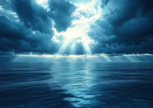 Sunlight piercing storm clouds over a vast open ocean, dramatic beams illuminating rippling blue water, evoking calm, awe and a serene atmosphere